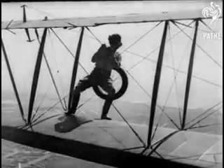 Gladys Ingle changes wheel in mid air