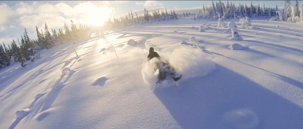 Beautiful snowmobile powder riding filmed with